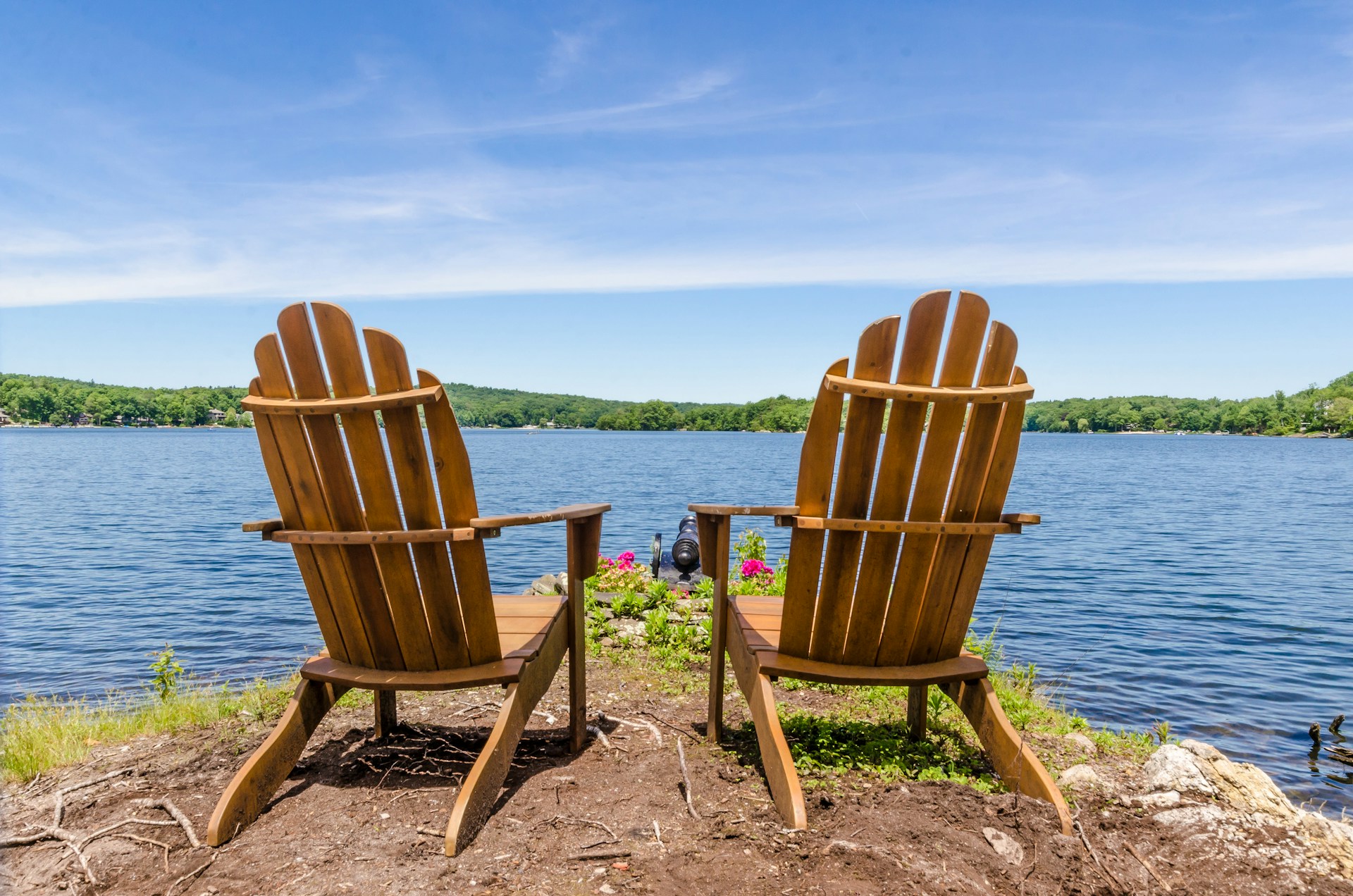 A collection of attempts Two white adirondack chairs, looking out upon a lake